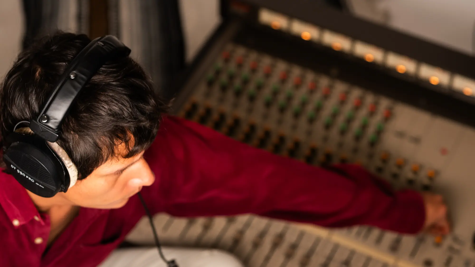 Engineer seen from above, leaning over the console