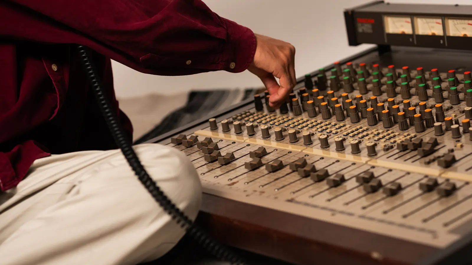 Close view of a hand setting a channel on the console